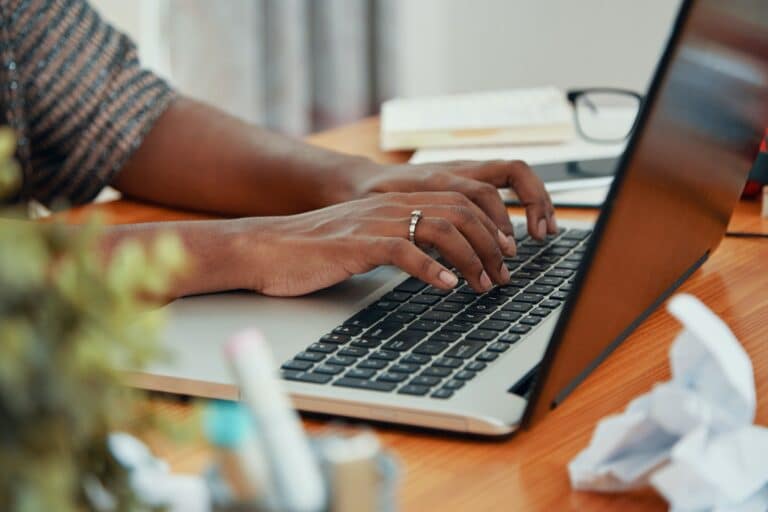 crop black woman typing on laptop 768x512 - Team