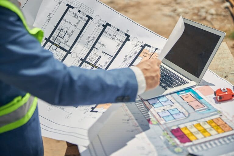 male constructor working on a technical drawing 768x512 - Team